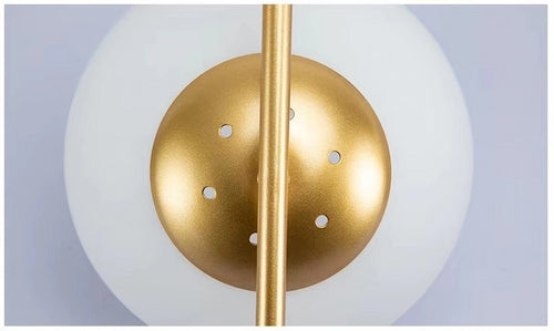 Détail structure fixation métal brossé or et globe lumineux luminaire de luxe — Maison Oria